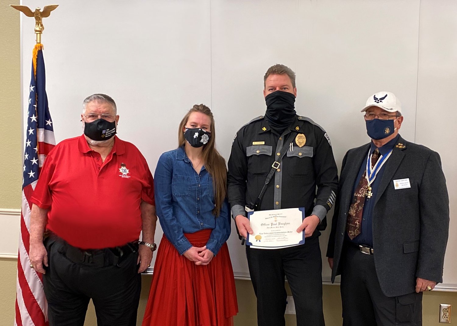 New Mexico State Police Officer Paul Vaughn, second from right, receives a Sons of the American Revolution (SAR) law enforcement commendation medal from SAR Gadsden Chapter President Don Williams, far left, and Past President Dave Curtiss. Also shown is Vaughn’s wife, Amy.