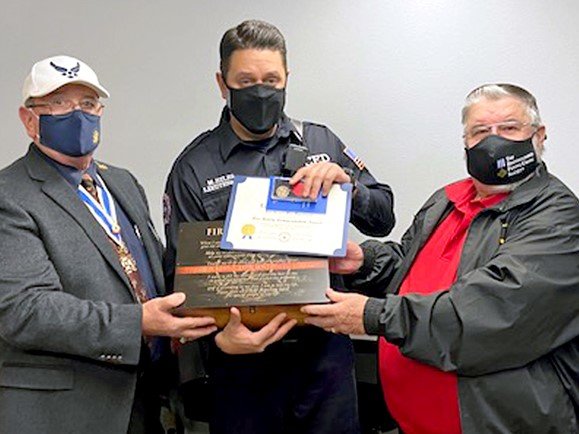 Sons of the American Revolution (SAR) Gadsden Chapter President Don Williams, right, presents an SAR fire safety commendation medal to Las Cruces Fire Department Lt. Matt Hiles. At left is Gadsden Chapter SAR Past President Dave Curtiss.