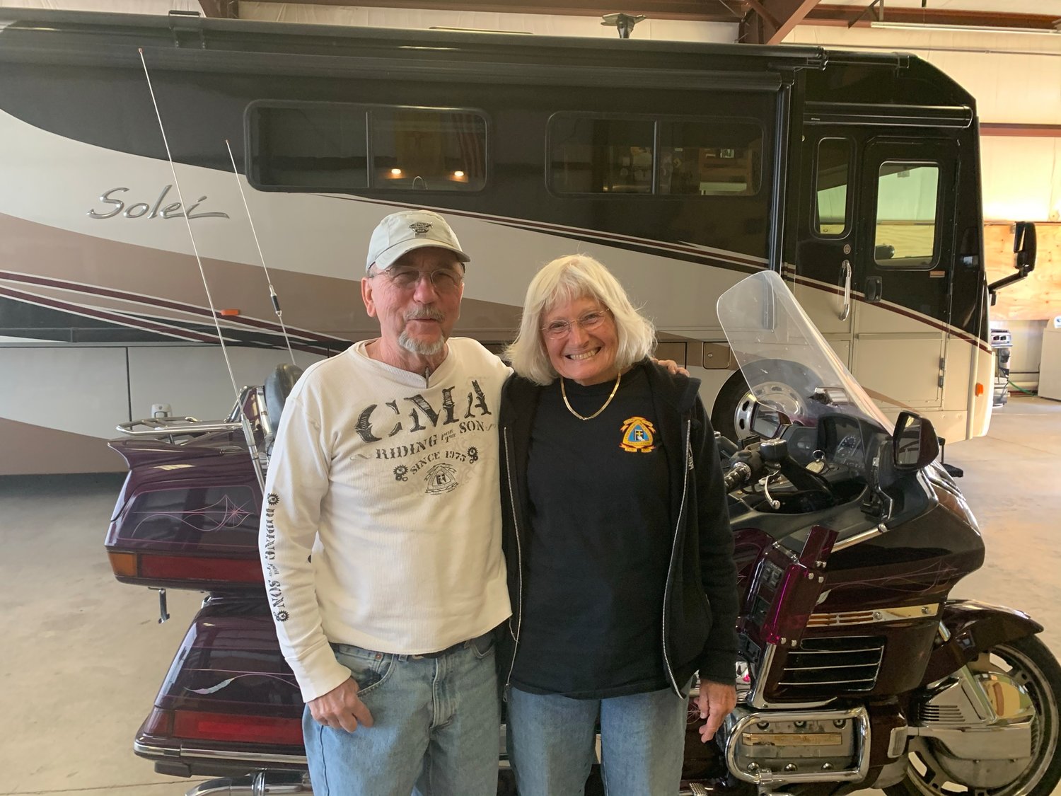 Tommy and Kathy Tucker at their new home in Mimbres where their RV and motorcycle fit into a converted airplane hangar.