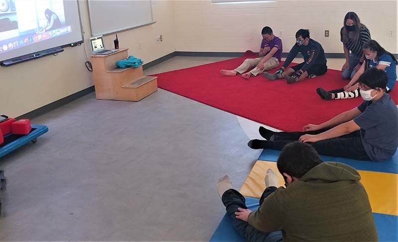 Students in Renee Loera’s class at Mesa Middle School practice yoga during a Zoom session with Downtown Desert Yoga instructor O’Dette Forsyth.