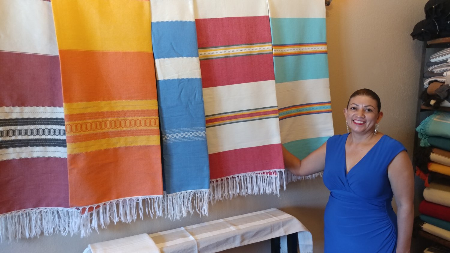 Claudia Albert with some of Rincón de Mesilla’s unique hand-woven textiles.