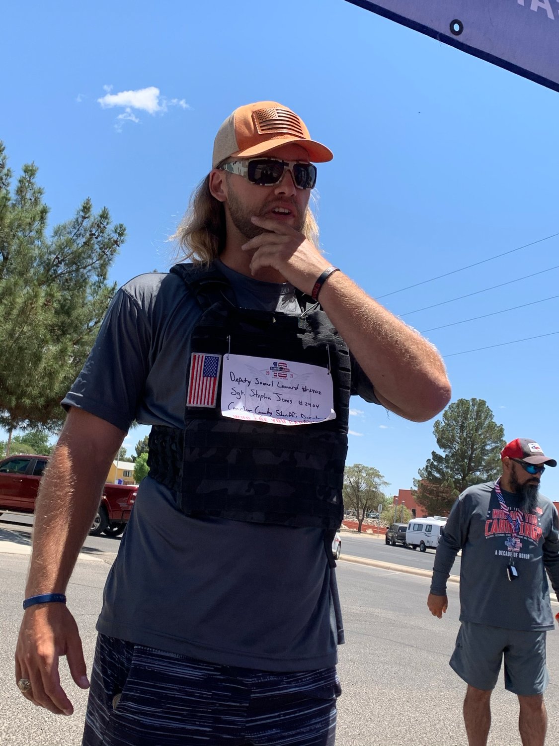 Jason Diggins, participating in one of the Las Cruces legs of Carry the Load relay, is wearing a bib with the names of two sheriff’s department officers who lost their lives in the line of duty.
