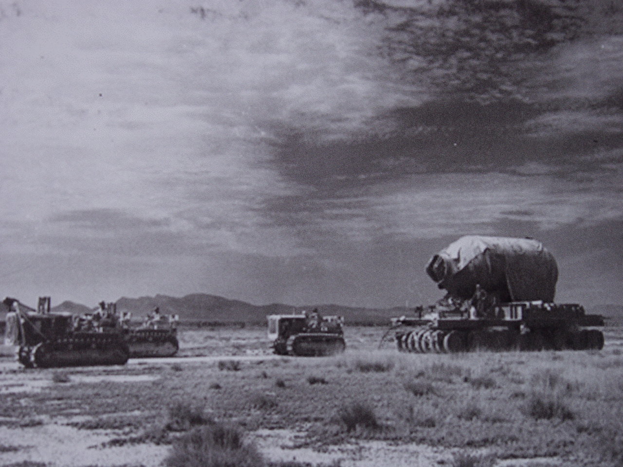 In this historic photo, military personnel are seen moving “Jumbo” to Trinity Site. One of the concerns of the scientists who built the “Gadget” nuclear device that was detonated at Trinity Site in 1945, was that the bomb might not actually go off. In order to preserve the 13 pounds of plutonium in case of failed detonation, an 80 ton steel vessel named “Jumbo” was built with the intention of imploding the device inside. The $12 million dollar vessel was never used for that purpose because by the time the test was nearly ready, scientists were confident that it would work. Instead, “Jumbo” was suspended on a steel tower 800 meters from ground zero. The tower was completely destroyed in the explosion, but “Jumbo” remained very much intact. Later, the military tried to destroy it using eight 500 pound bombs, but only succeeded in blowing the ends off of it. What remains can still be seen at Trinity Site today