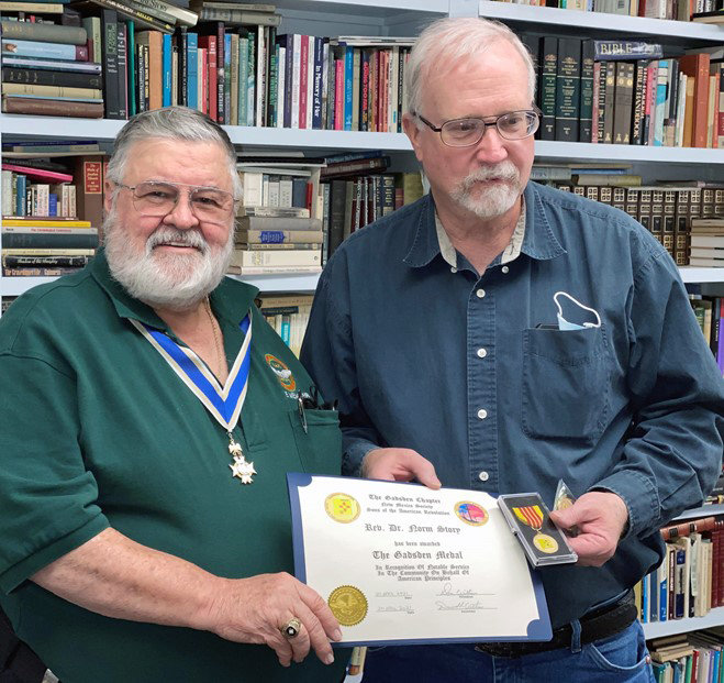 Sons of the American Revolution Gadsden Chapter President U.S. Army Capt. (Ret.) Don Williams, left, presents the chapter’s community service award to Rev. Dr. Norm Story.