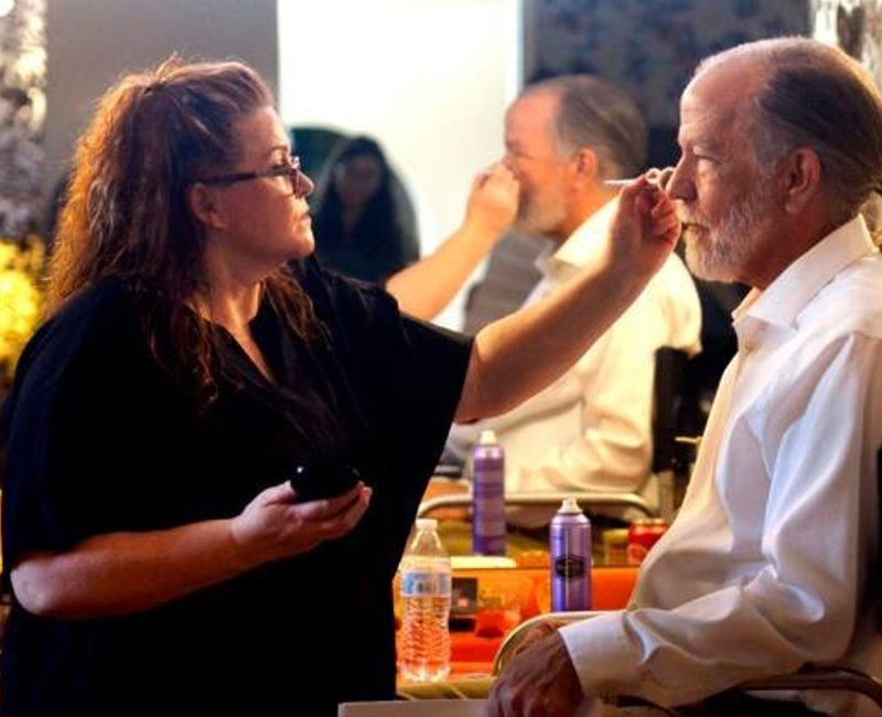 Pepper Gallegos finishing the makeup on Daniel Grochowski for the short film “Home Movies.”