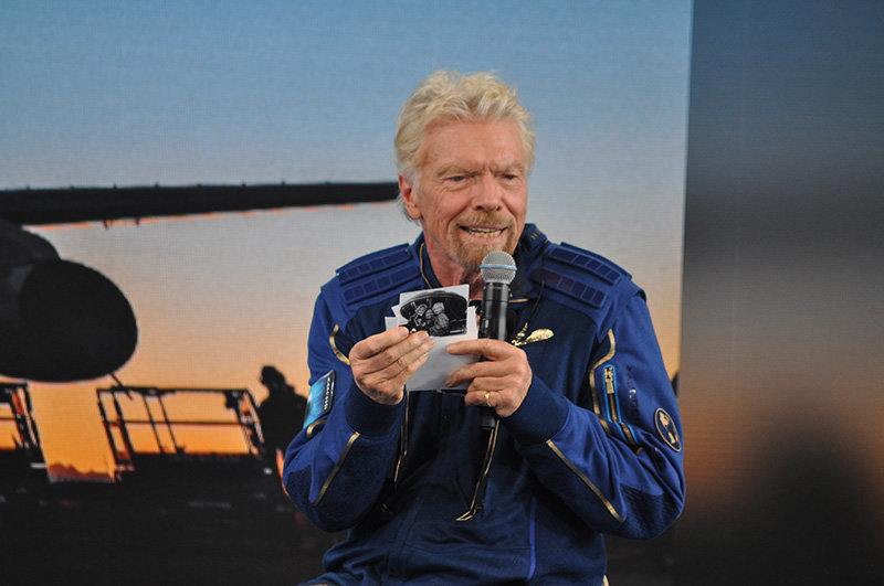 Sir Richard Branson shows photos that he carried to space with him on the Unity 22 flight. This one has his mother and himself as a child.