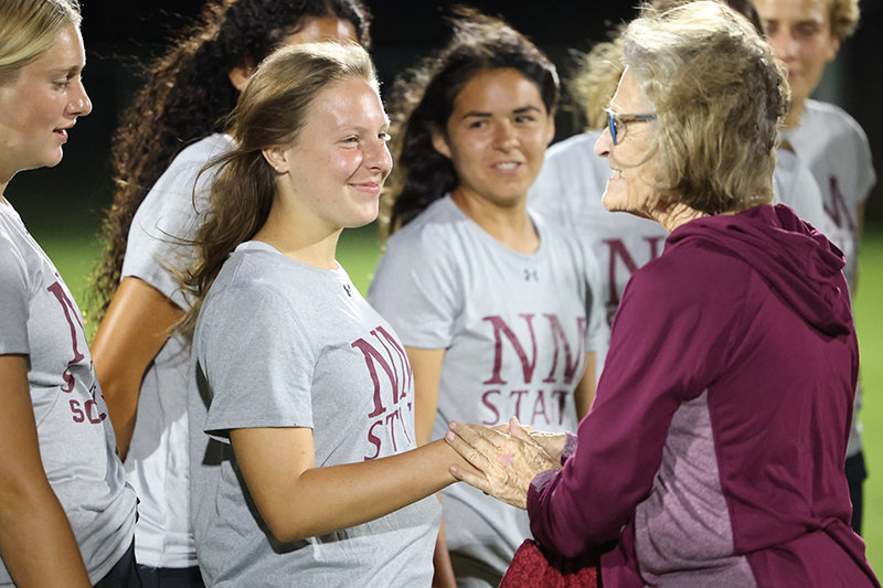 Members of the NMSU women’s soccer team thank former state Sen. Mary Kay Papen for securing the funding for lights for the soccer complex.