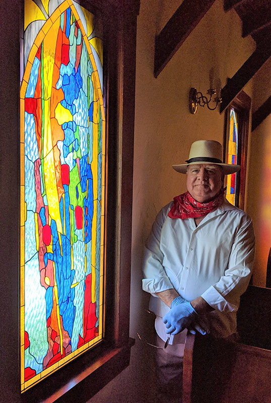 Las Cruces artist Frank Peacock at St. Andrew’s Episcopal Church’s Kendrick Chapel during the installation of the eight stained-glass windows he made for the chapel.