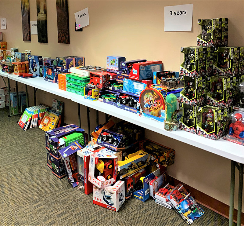 Tresco, Inc. employees with some of the toys they collected during a previous year’s toy drive.