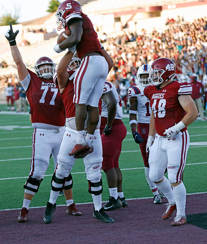 New Mexico State University celebrates O’Maury Samuels’ first touchdown of the season during the Aggies’ 43-35 win over South Carolina State on Sept. 18.