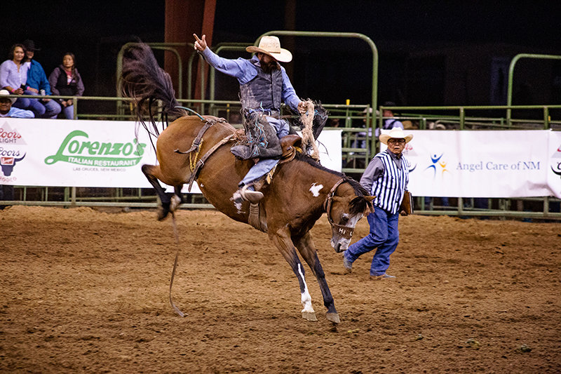 Brandon Blakely tries to hang on a bronco during the saddle bronco riding competition Saturday night, Oct. 2, at the Southern New Mexico State Fair.
