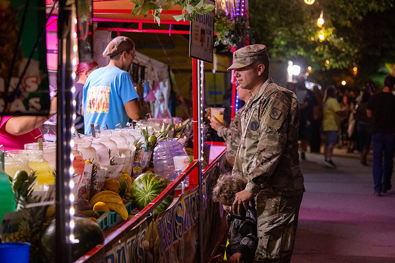U.S. Army Sgt. Christian Aguirre buys a treat for his son Alessandro Aguirre, 2, Saturday night, Oct. 2, at the Southern New Mexico State Fair.