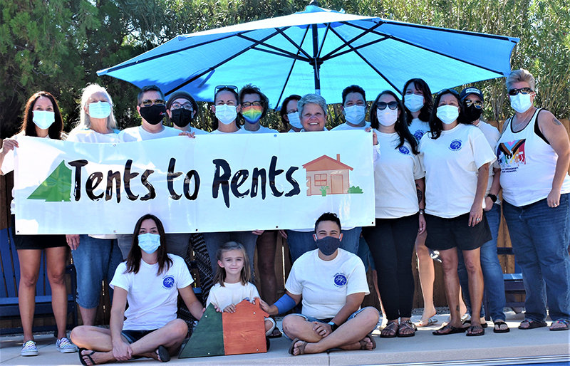 Friends of Doña Ana Community College President Dr. Monica Torres, shown at center, holding one end of the banner, contributed the weekend of Oct. 2-3 to Torres’ Tents to Rents campaign to help Mesilla Valley Community of Hope (MVCH) end homelessness.