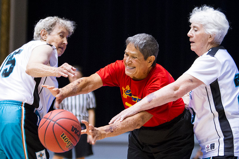 Mickey Mckenzie ,left, Betty Platt, and Arlene Mayer, 80+ age division, reaches for the ball while competing against cross town rivals from Albuquerque, New Mexico compete for the gold medal in the National Senior Games held in the 2013, in Cleveland, Ohio.