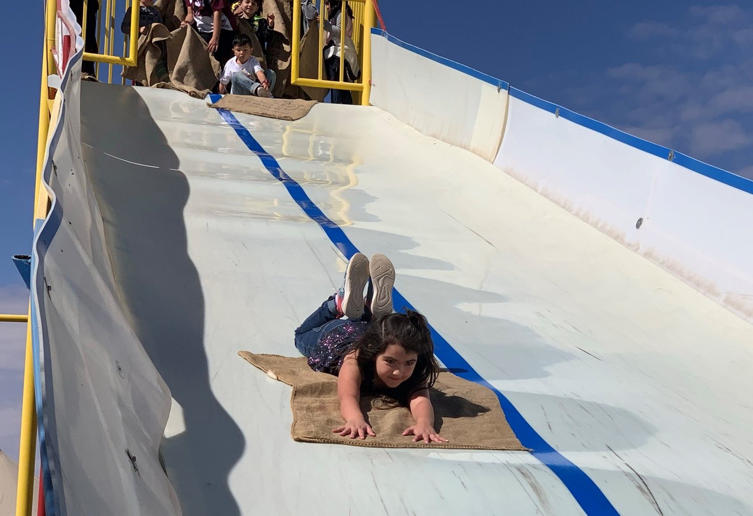 Autumn Rodriguez is focused on her destination as she slides down one of the slippery tracks at La Union Maze.