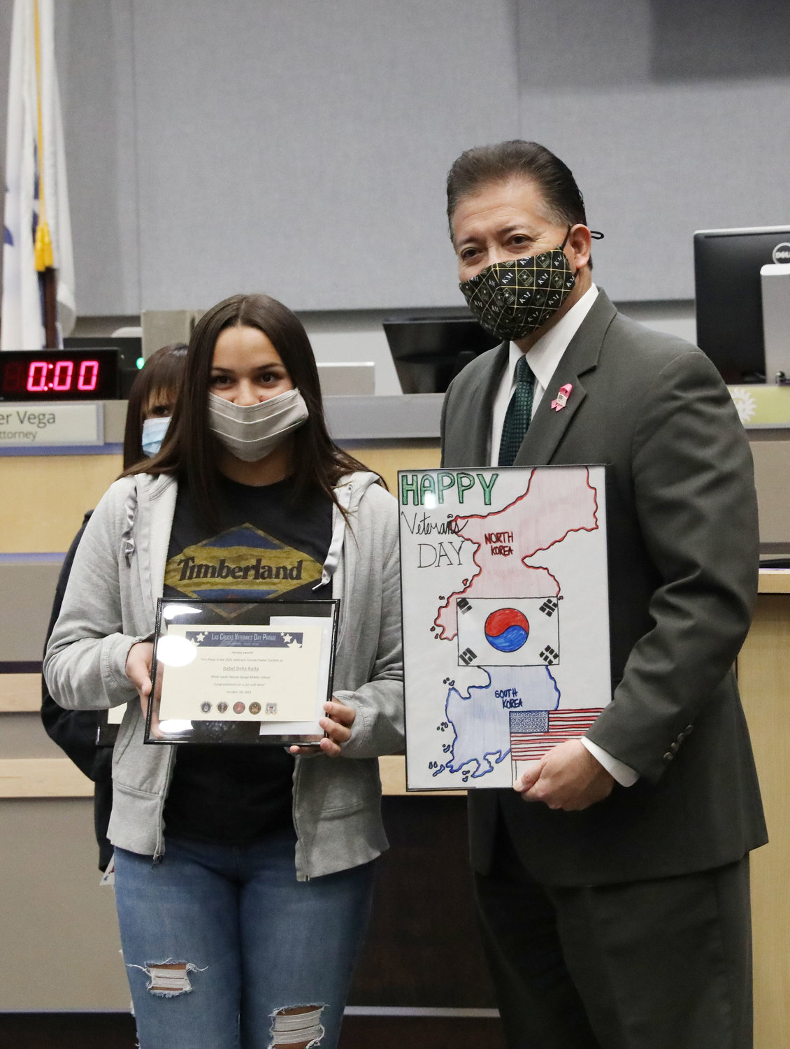 Isabel Della-Ratta, an eighth grader at White Sands Middle School, was the winner of the City of Las Cruces 2021 Veterans Parade Poster Contest. She is shown here with her winning entry with Mayor Ken Miyagishima at the Las Cruces City Council’s Oct. 18 regular meeting. Isabel won $40 for her first-place poster and will be featured in the Nov. 6 parade. The committee has held a parade poster contest for Las Cruces middle and high school students since 2015. There were 150 submissions this year, with six winners selected for first-, second- and third place, along with honorable mentions.