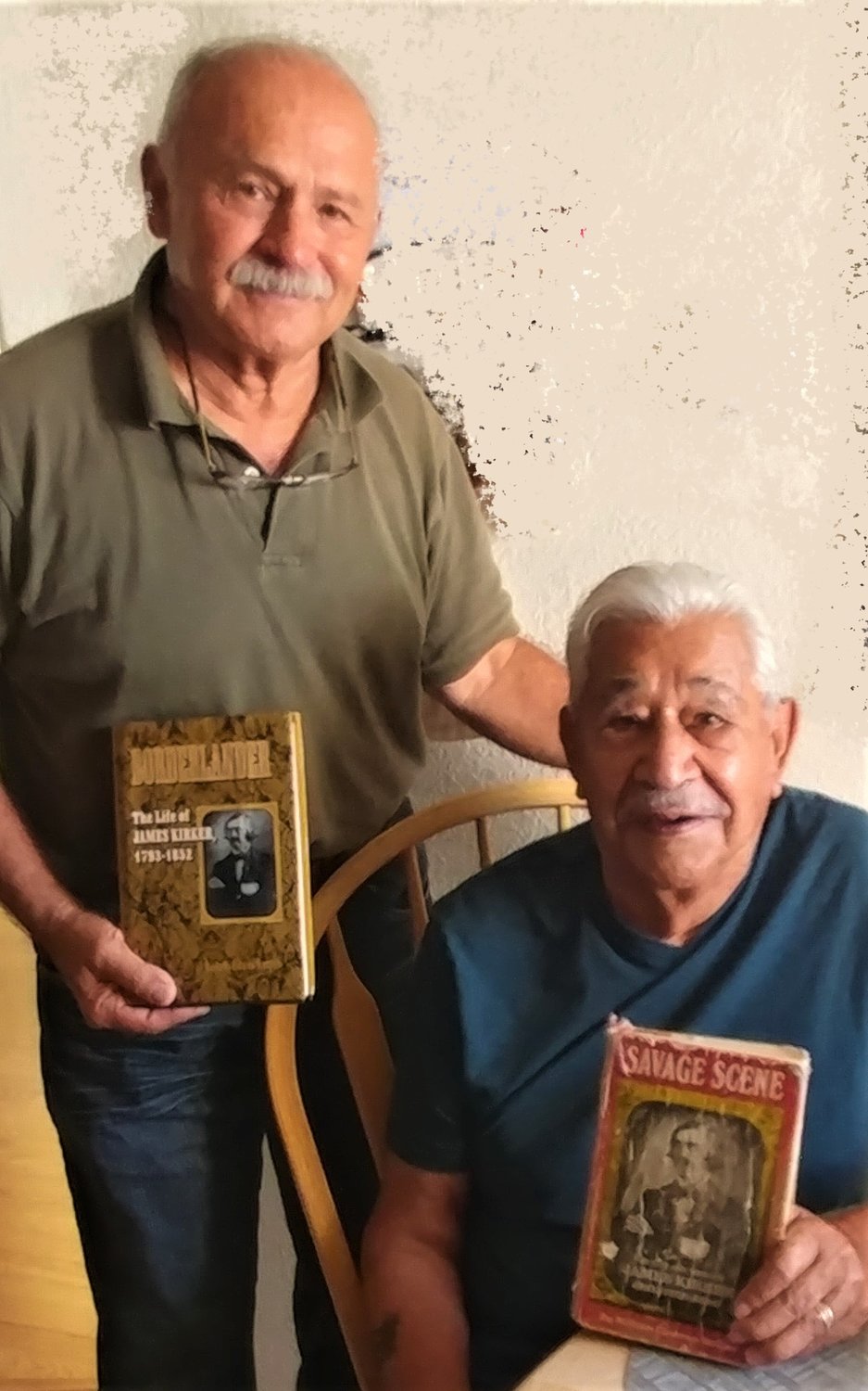 Daniel Aranda, left, and Robert Kirker with two books written about Kirker’s great-grandfather, James Kirker