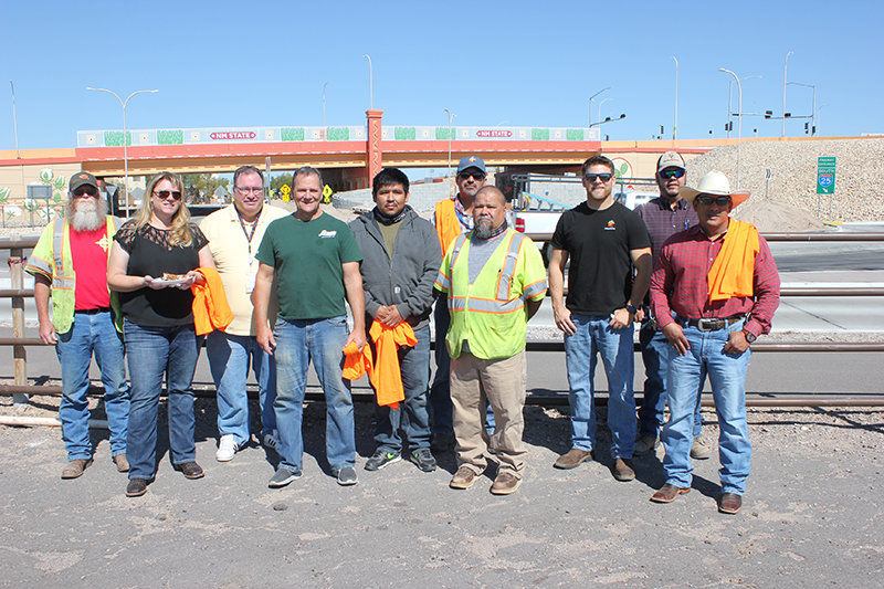 Construction workers, planners, New Mexico Department of Transportation staff and others gather with Lorenzo’s Italian Restaurant owner Vince Vaccaro to celebrate completion of the Interstate 25/University Avenue exchange project.