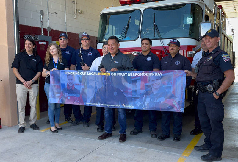 Electronic Caregiver Care Coordination Executive Director John Muñoz is featured in the center with the NMSU Fire Department photo, along with other ECG staff.