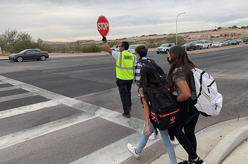 At Roadrunner Parkway at the Camino Real Middle School location Las Cruces Public Schools Security officer Vince Ramirez-Santome has stepped in to serve as crossing guard to help slow down the traffic and safely help students get across the road.