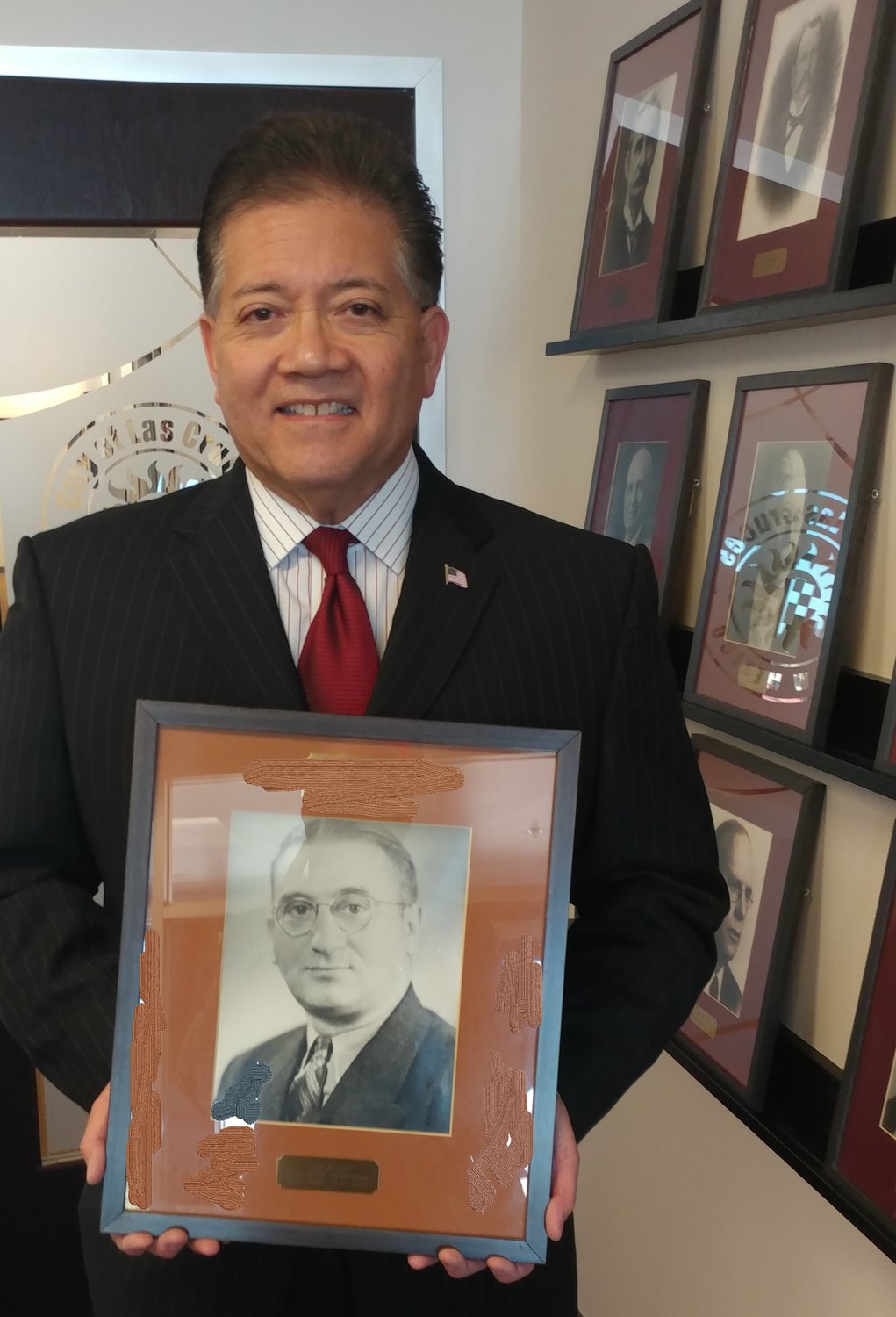 Mayor Ken Miyagishima holds a photo of former mayor Sam Klein, whom Miyagashima overtook this month to become the longest serving mayor in Las Cruces history.