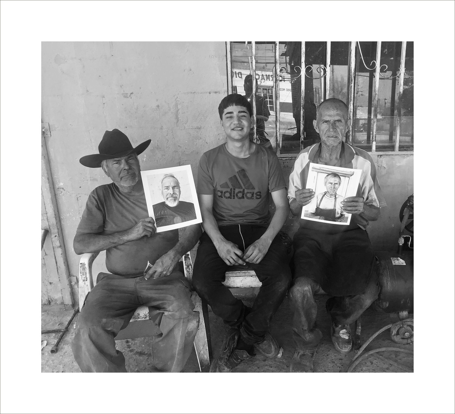 3.Francisco and Fernando with their photos, Fernando’s nephew in the middle.