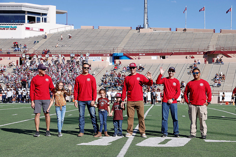 Members of the Las Cruces Fire Department, and some of their children show their Aggie pride at a recent football game at Aggie Memorial Stadium. From left to right are Las Cruces Fire Chief Jason Smith, Lt. Cody Richards, Lt. Dominic Soucy, Battalion Chief Justin Whitefield and firefighter Matthew Castrejon.