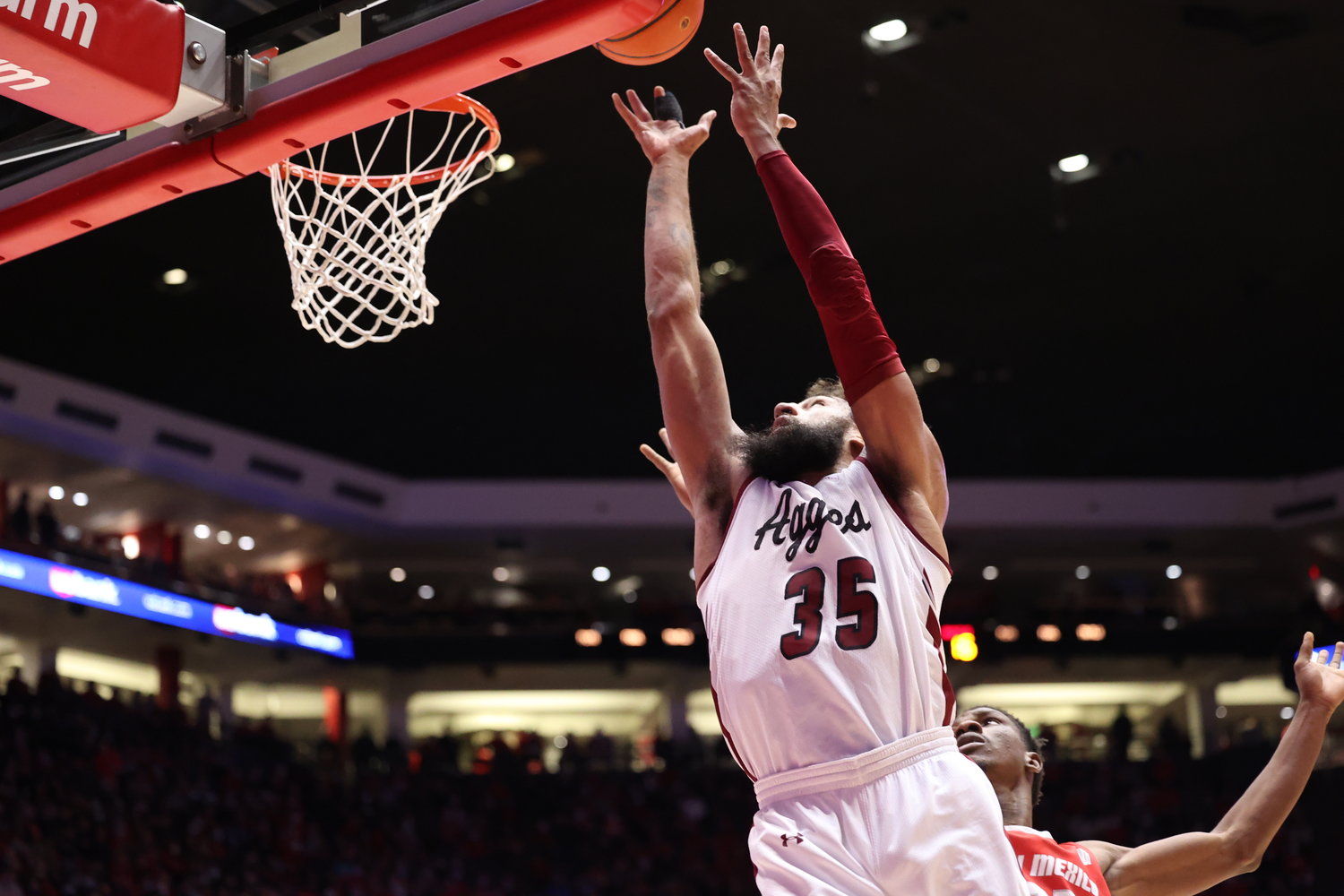 New Mexico State University’s Johnny McCants grabs a rebound against the University of New Mexico Dec. 6 in The Pit in Albuquerque.