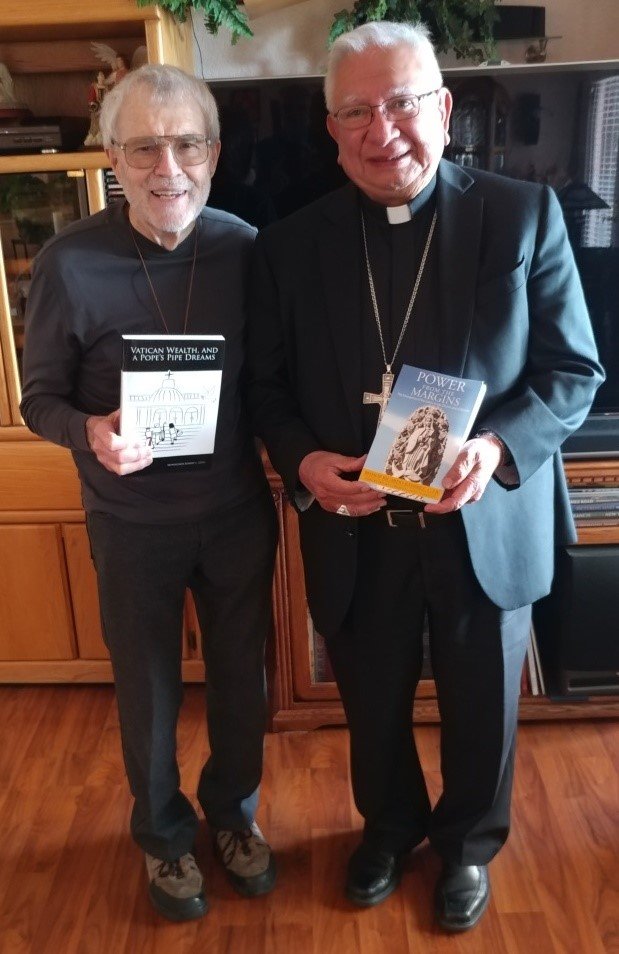 Monsignor Robert Getz, left, with Most Rev. Ricardo Ramirez and the books they wrote, in a 2017 photo.