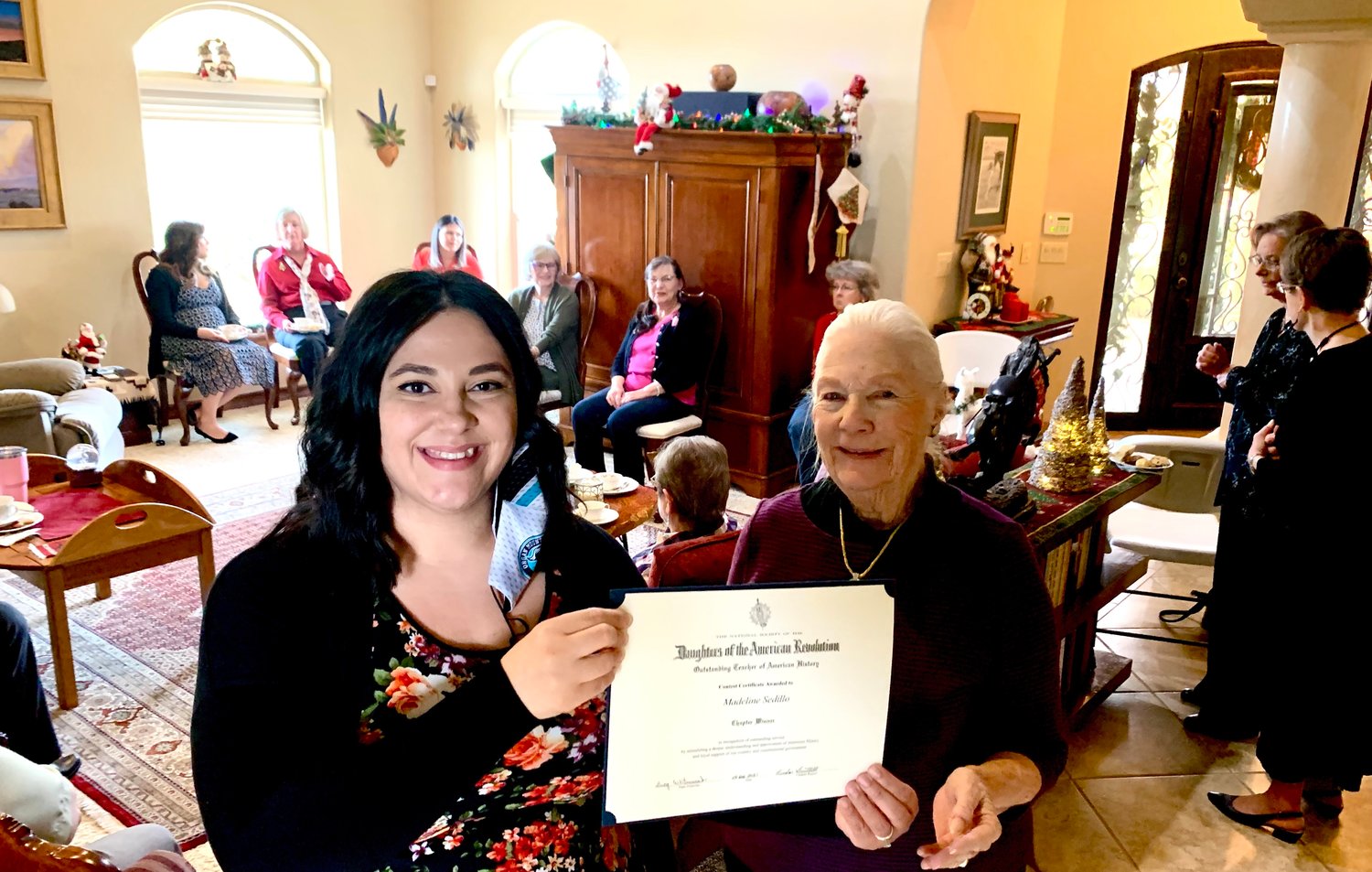 Bonnie Poloner, right, presents Madeline Sedillo with the chapter’s Outstanding American History Teacher Award at the DAR Christmas tea.
