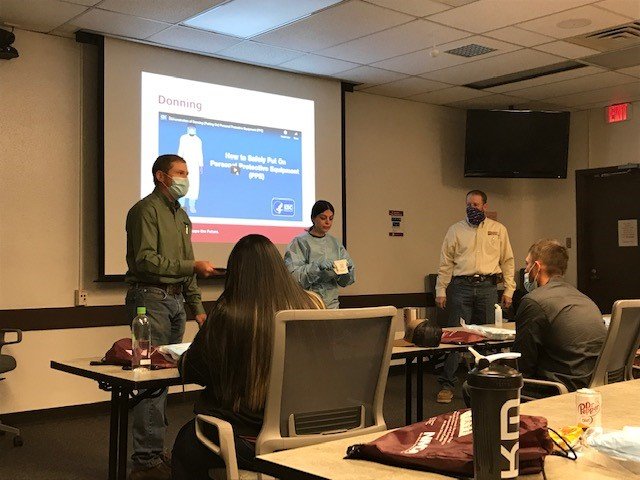 Southwest Border Food Protection and Emergency Preparedness Center co-directors Marshal Wilson, left, and Tom Dean, far right, giving a demonstration at NMDA new employee orientation in November.