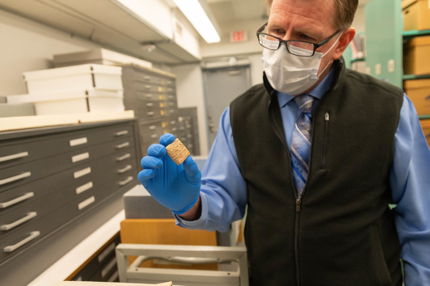 Dennis Daily, director of the NMSU Archive discusses some of the material in the Rio Grade Collection, showing the oldest piece they have in the archive an ancient recipt from the Middle East. December 2, 2021. (NMSU photo by Josh Bachman)