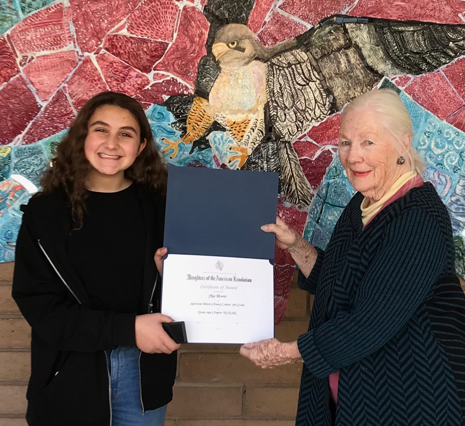 Daughters of the American Revolution, Doña Ana Chapter member Bonnie Poloner awards Mia Homsi her DAR American history essay certificate.