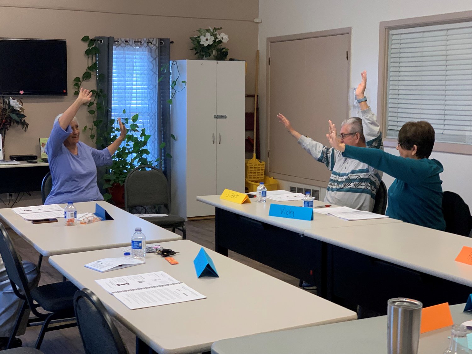 Instructor Chris Milyard works with the February Matter of Balance Class on their exercises. Participants Gilbert and Vicky Peña