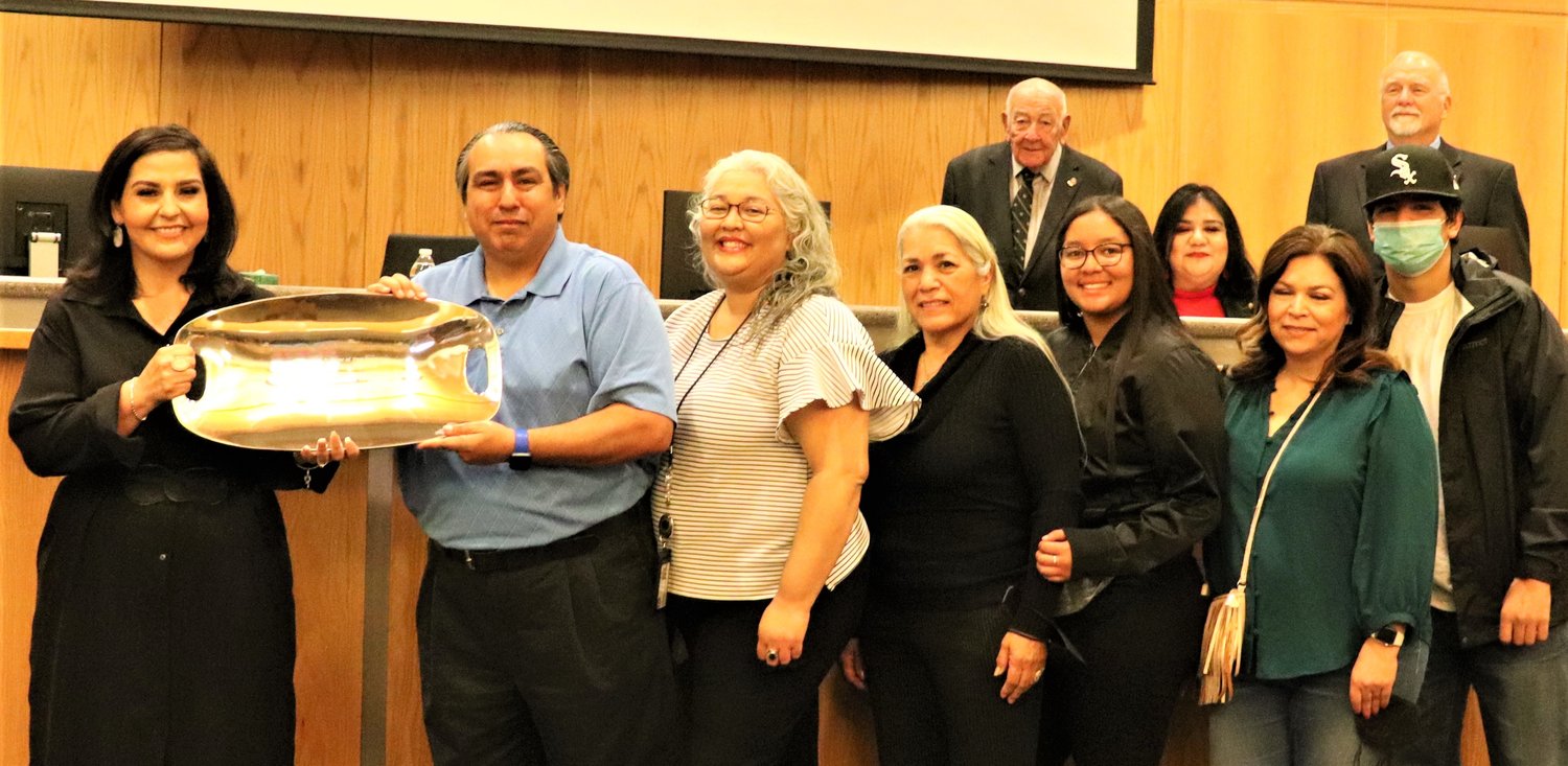Doña Ana County Bureau of Elections Supervisor Andy Perez, second from left, was honored at the Feb. 22 Doña Ana County Commission meeting for 25 years of service to the county. At far left is County Clerk Amanda López Askin. To Perez’s left are members of his family.