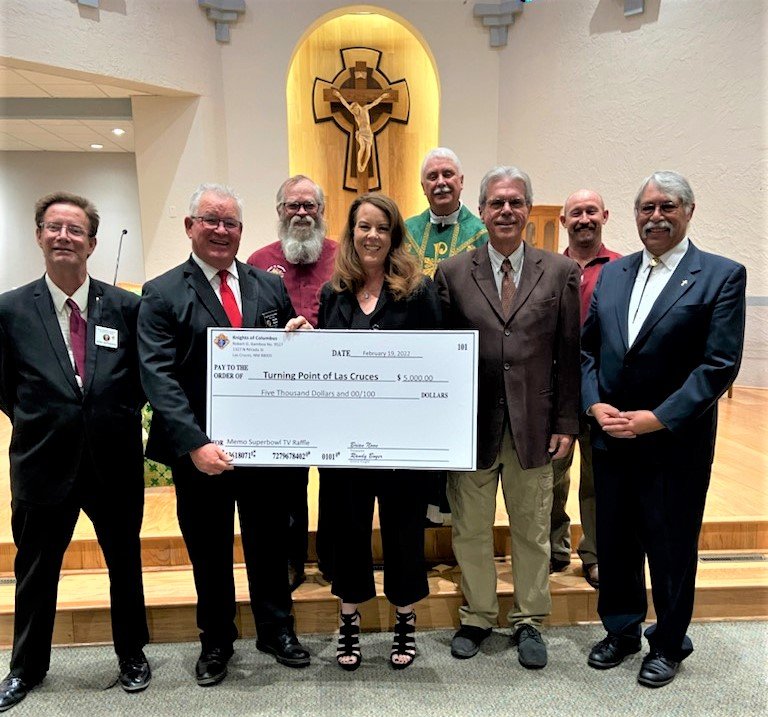 Left to right are Revel McPherson, Knights of Columbus Grand Knight Randy Boyer, Joe Fleming, Debbie Taylor of Turning Point, Father Richard Catanach of Holy Cross Church, Knights of Columbus Treasurer Brian Noon, Kyle Dominguez, and Randy Rivas.