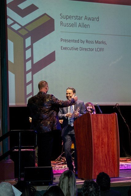 Russell Allen, left, accepts the Superstar Award Saturday night at the Rio Grande Theater from Ross Marks, the Executive Director of the Las Cruces International Film Festival.