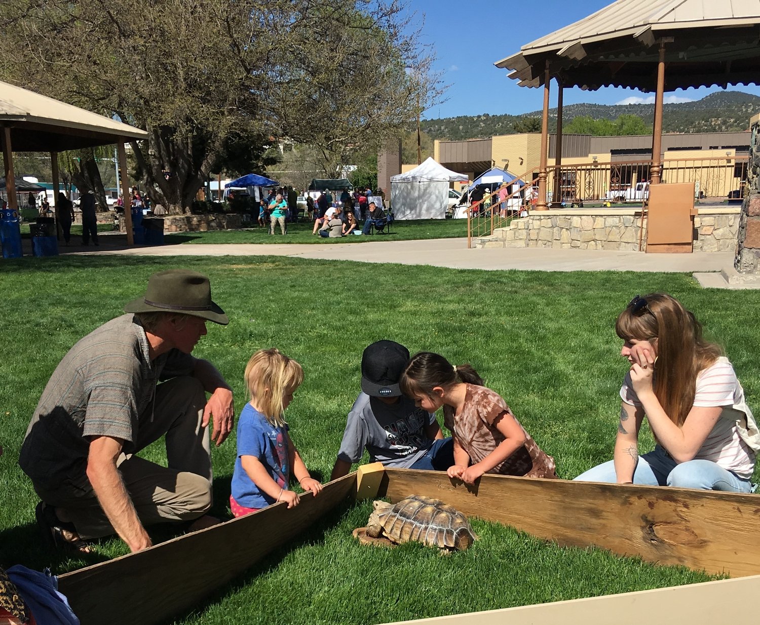 Indi Blake of the Silver City Watershed Keepers introduces Flower the tortoise to new friends at a previous Gila Earth Day.