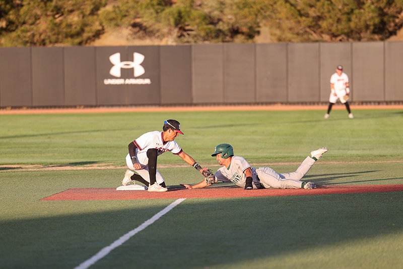 NM State’s Kevin Jimenez tags out a base runner trying to
steal second April 8 in a game with Sacramento State.