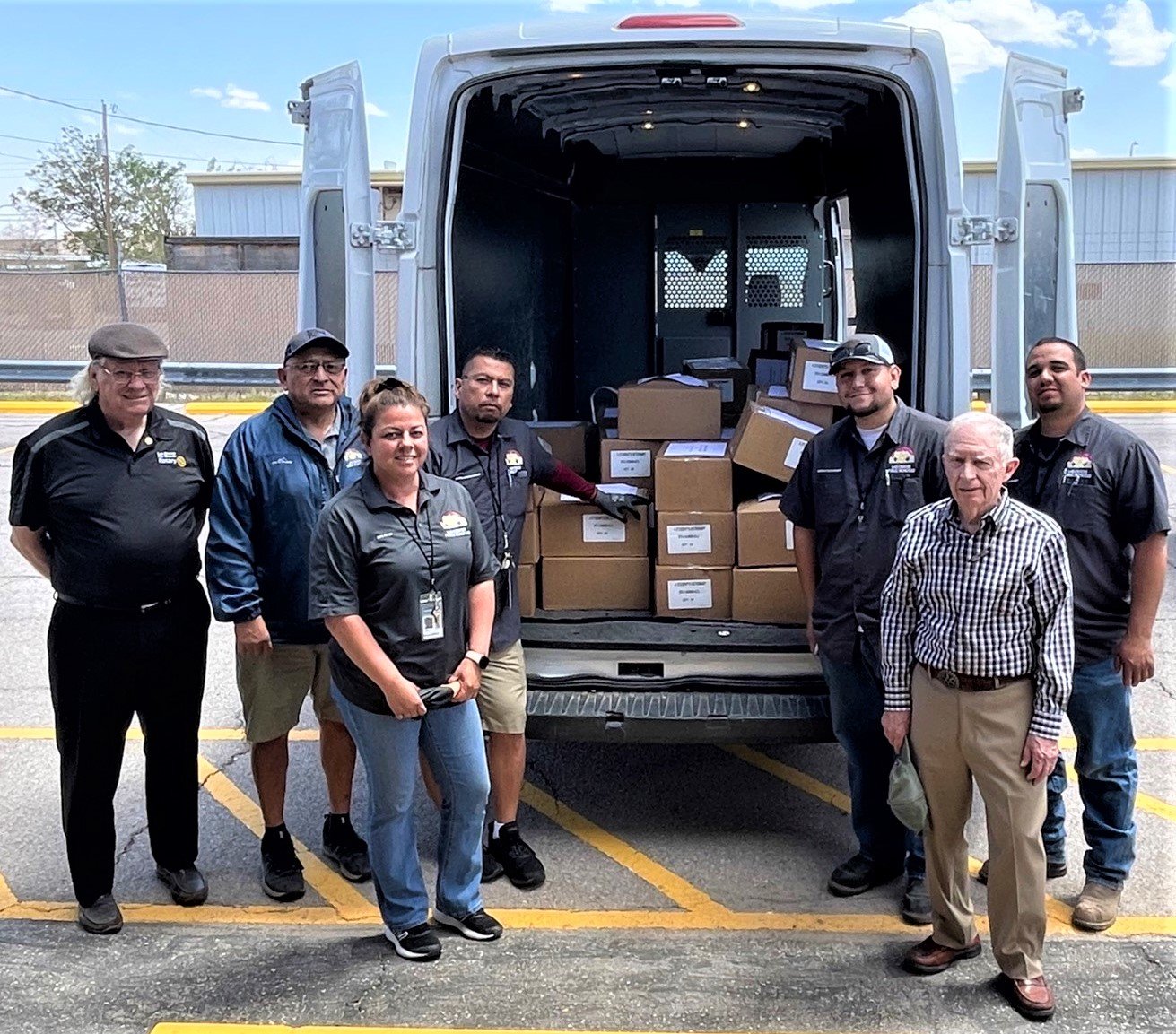 Gene Gant, far left, and Rob Shelton, in the front at right, of the Rio Grande Rotary Club with Las Cruces Public Schools Materials Management team, left to right, Johnny Robles, Veronica Lopez, Michael Gay, Dominic Maldonado and Albert Lucero as they begin delivery of nearly 1,800 dictionaries donated by the club to third graders in 26 elementary schools in the district.
