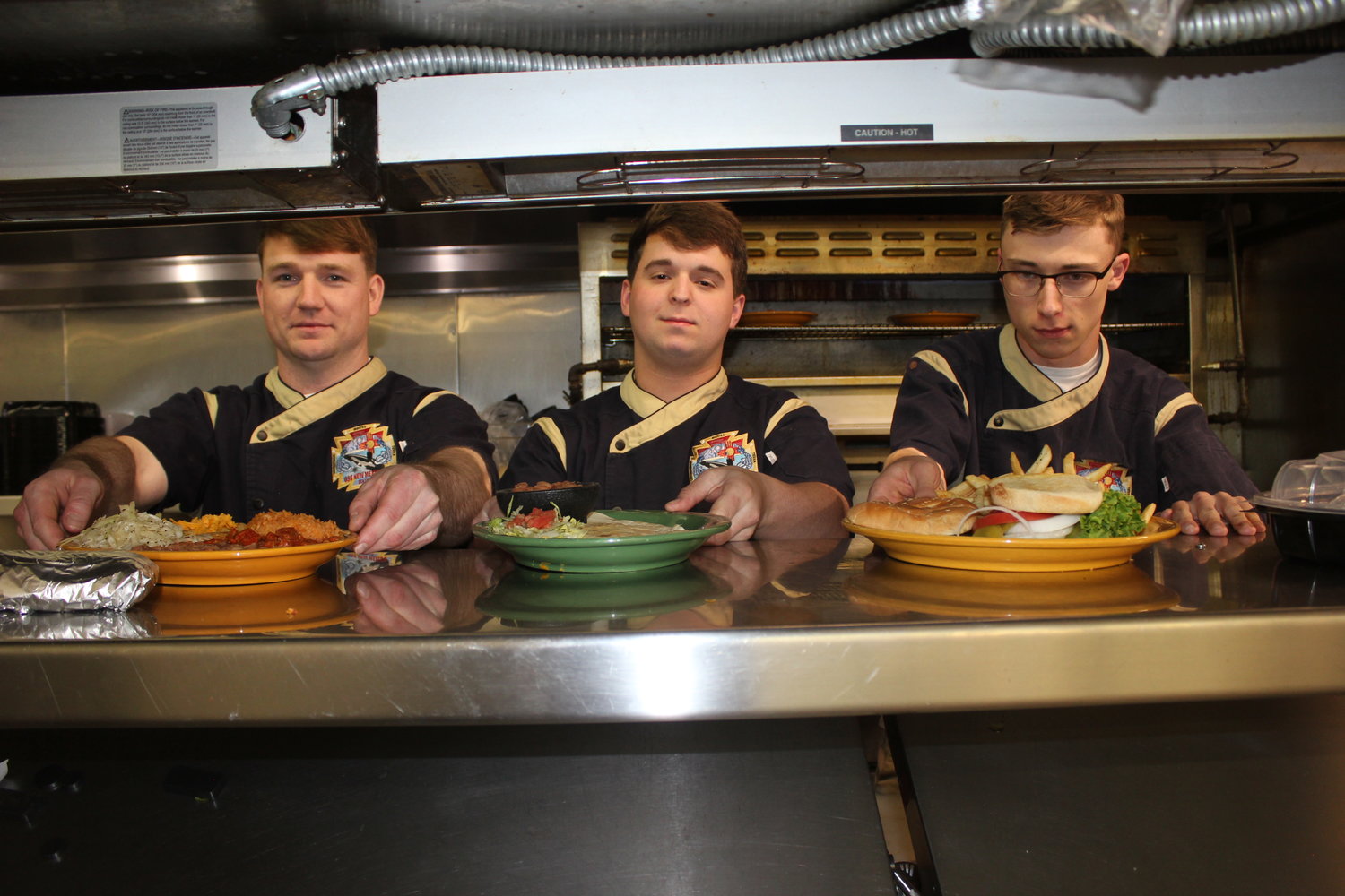 Kyle Scott, Cole Pagels and Nick Armantrout Buckler, culinary specialists from the Navy Submarine USS New Mexico, recently trained in the kitchen of La Posta de Mesilla, the namesake of their sub’s galley.