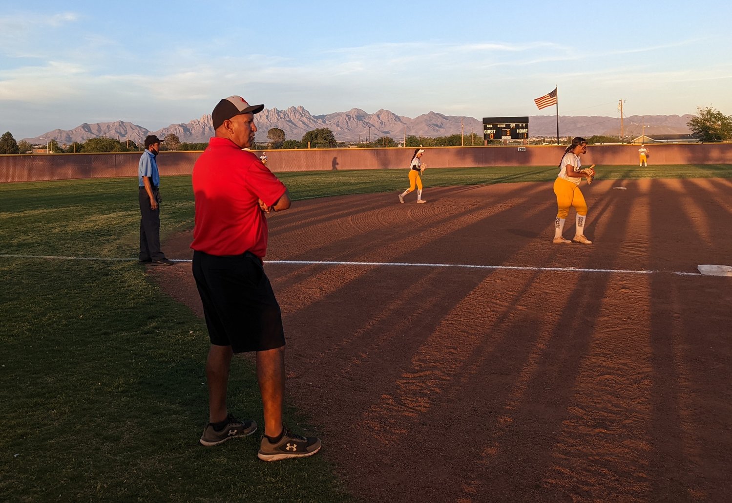 Centennial softball coach Fernie Valles coaching third base.