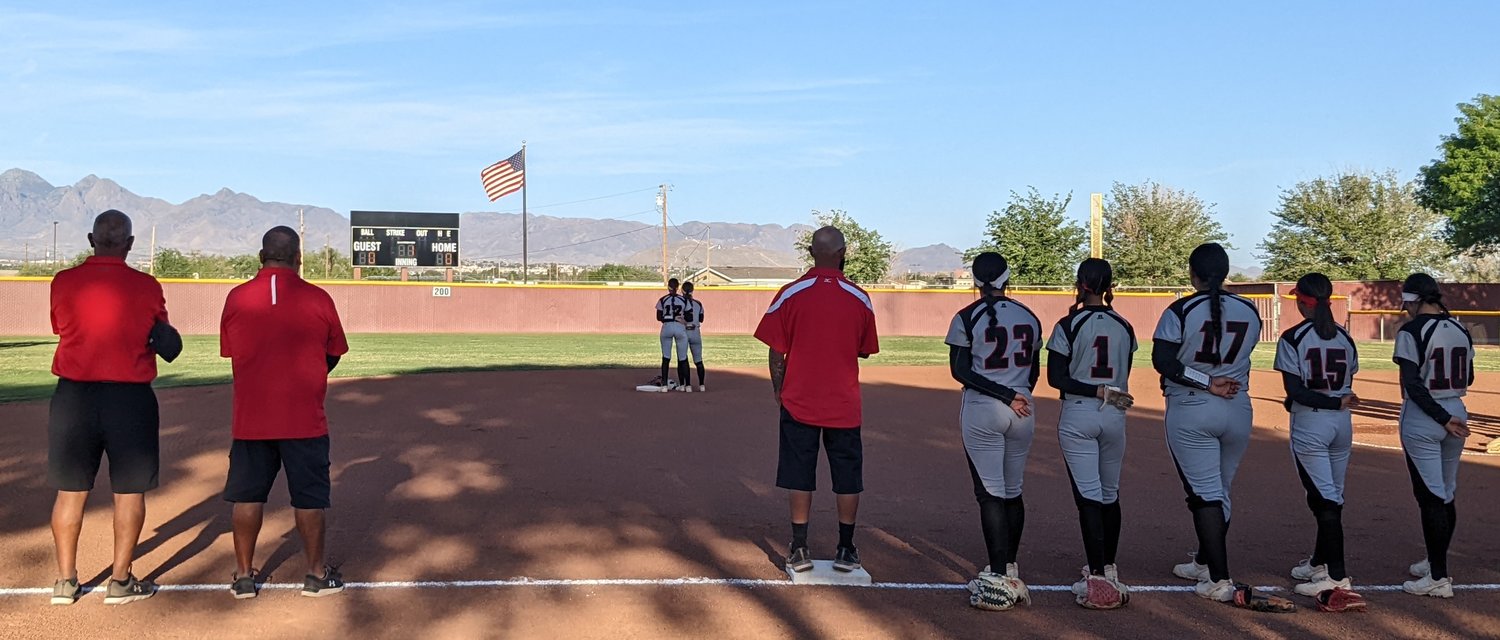The Centennial High softball team listens to the national anthem before taking the field against Cibola High int he opening round of the state playoffs Friday, May 6.