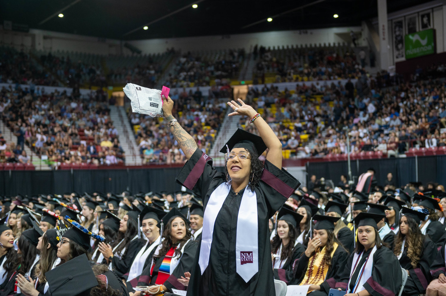 Erin Small waves to friends and family before she recieved her diploma during the New Mexico State University Spring 2022 Commencement Saturday May 7, 2022.(NMSU photo by Josh Bachman)