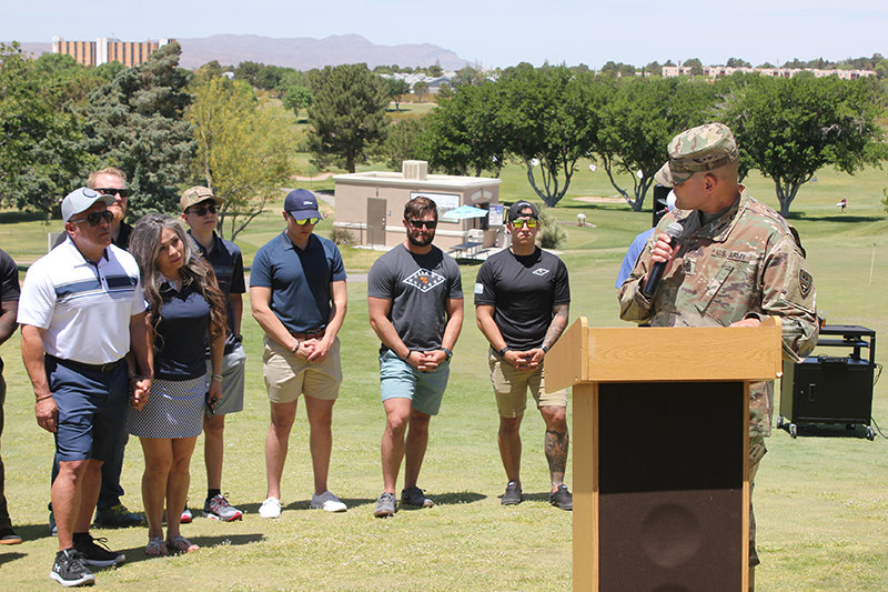 Command Sgt. Maj. Jose Melendez of White Sands Missile Range addresses the audience prior to the SFC Antonio Rey Rodriguez Golf Tournament, here giving a special message to Rodriguez’s mother, Lupe Rodriguez-Jaramillo, flanked by her husband, Javier Jaramillo and her son, Christopher James Rodriguez-Jaramillo, as well as U.S. Army Rangers who served with Rodriguez.