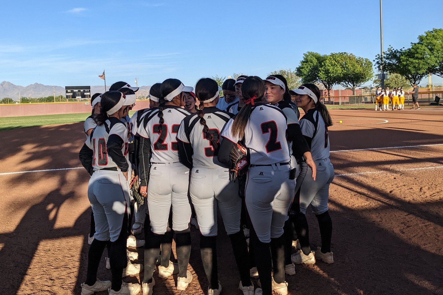 The Centennial High softball team huddles before its first round 5A playoff game against Cibola Friday, May 6, at the Field of Dreams.