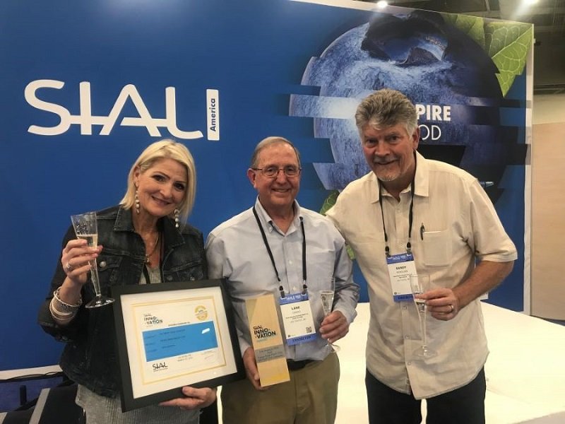 Carol McMillan, Lane Grado and Randy McMillan of The Fresh Chile Company pose with the SIAL America 2022 Gold Innovation Award.