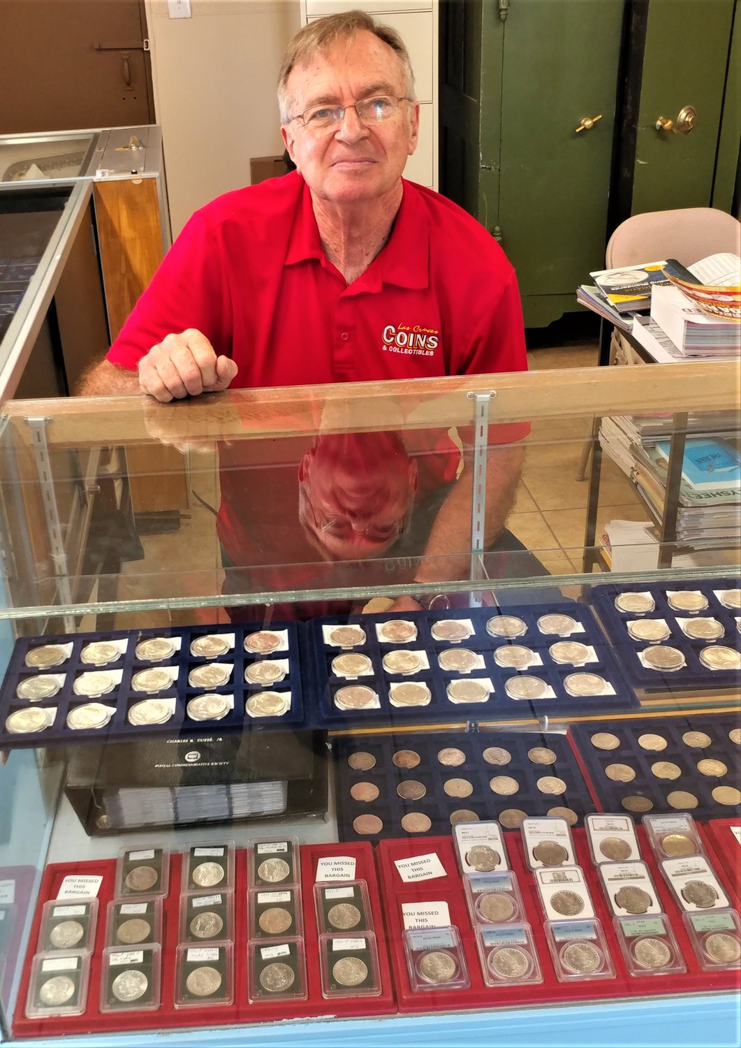 Las Cruces Coins and Collectibles co-owner Gary Henderson with some of what the store has available to collectors and investors.