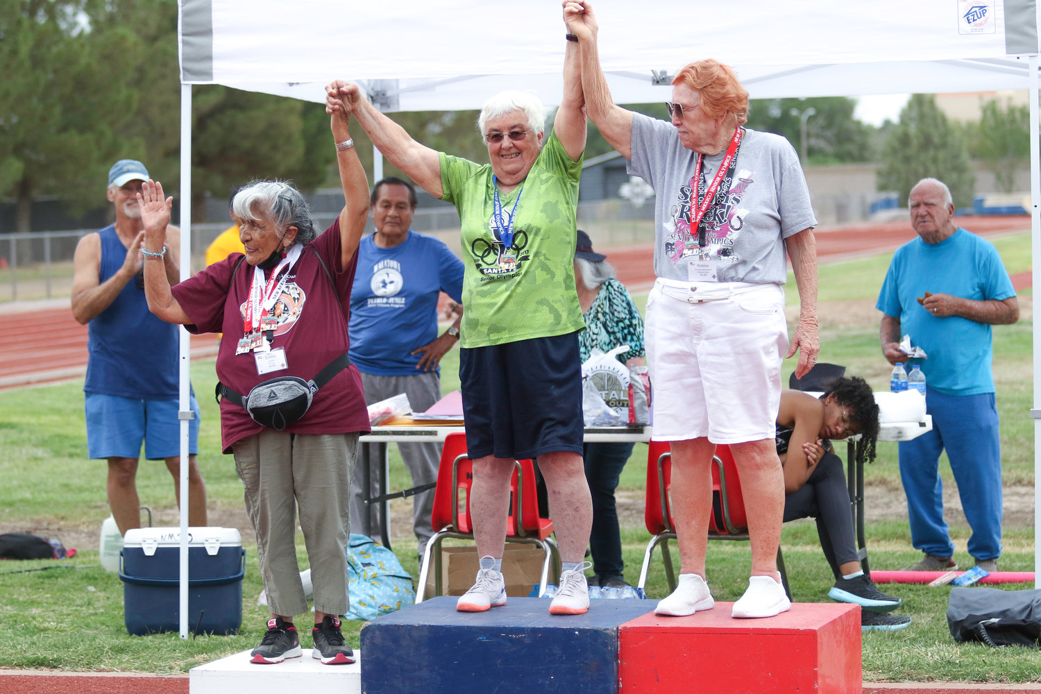 On the winner’s stand for javelin in the 85-89 age group are Ema Liptow from Acoma in third place, Barbara Hutchison of Santa Fe in first place and Robbie McFarland of Elephant Butte in second.