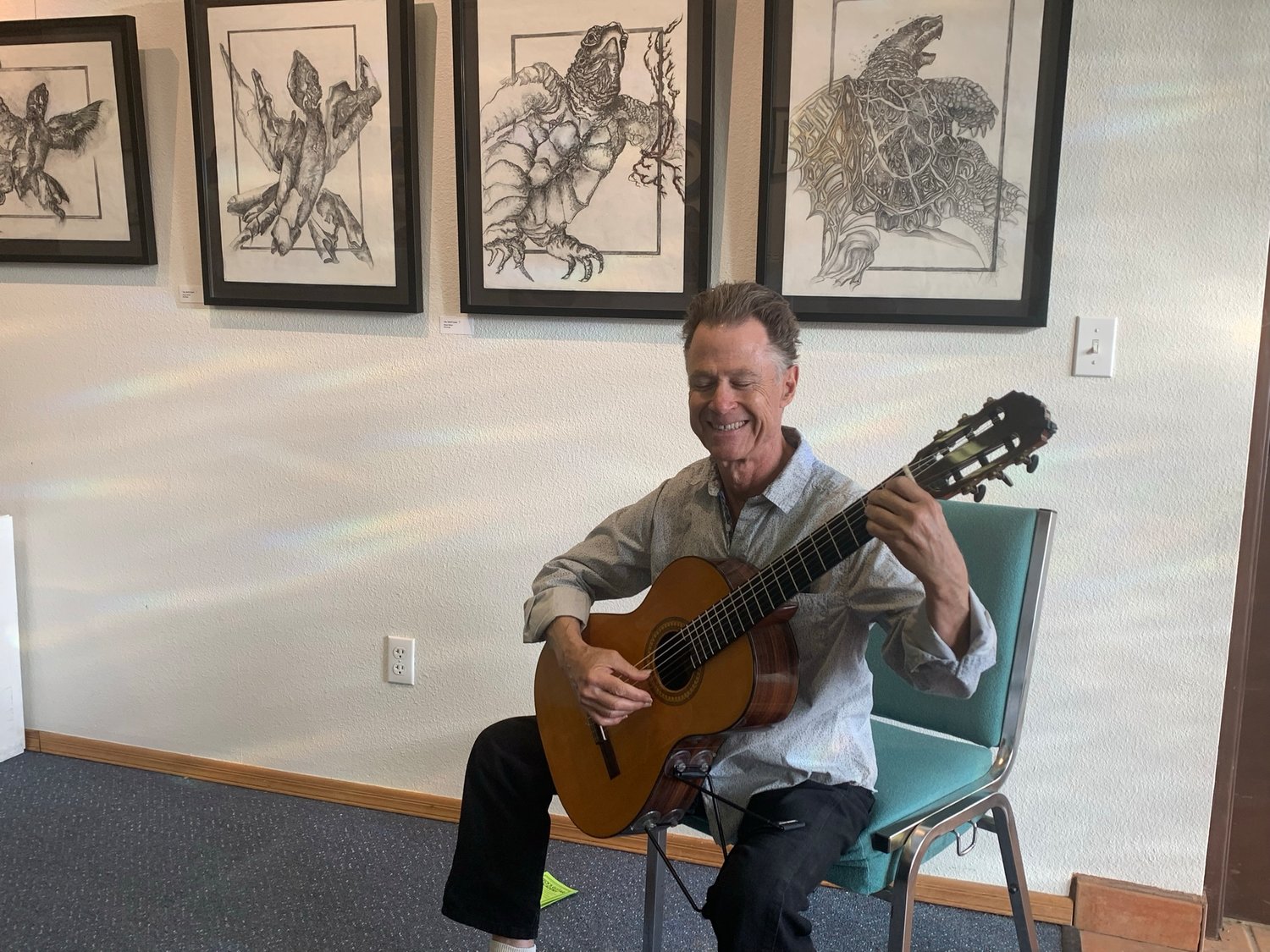 Hunter Beck plays his classical guitar for an art opening at the Tombaugh Gallery in May.